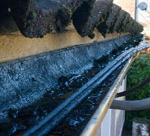 Using cable in a gutter will lead to damage to the casing, a professional will do the work needed to route the cable properly